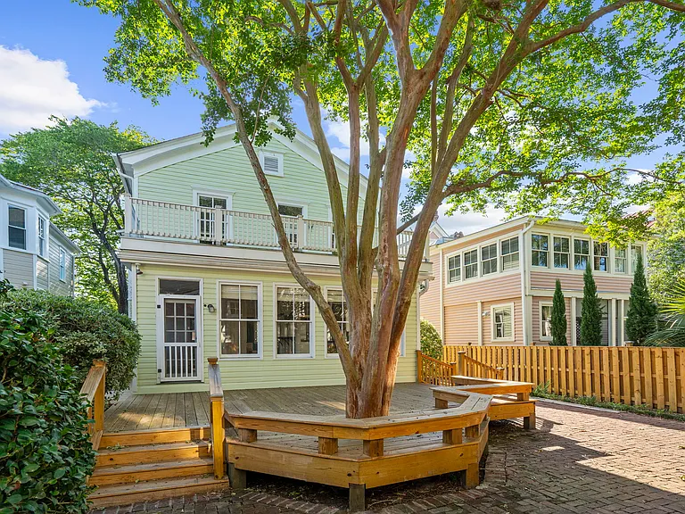 Back of House with Deck and Brick Paved Yard