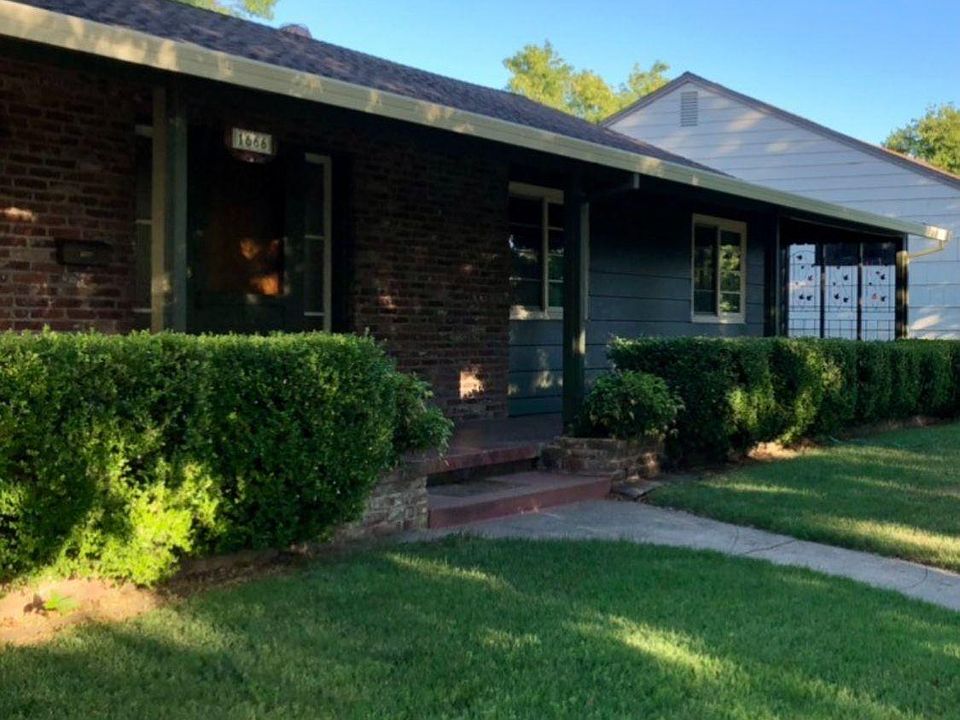 Front of house, with full length covered porch.