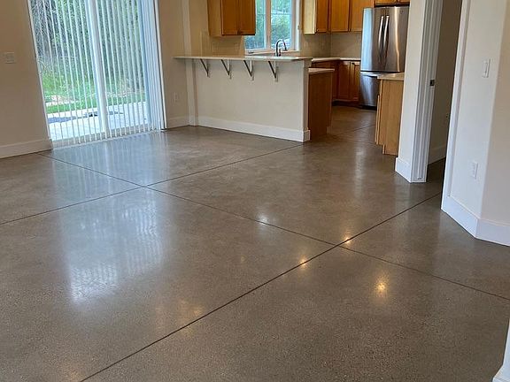 From the front door, open plan living, dining, and kitchen. Primary bed/bath door