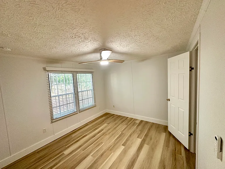 One of the secondary bedrooms, with its own closet. New ceiling fan, window blinds, smoke detector