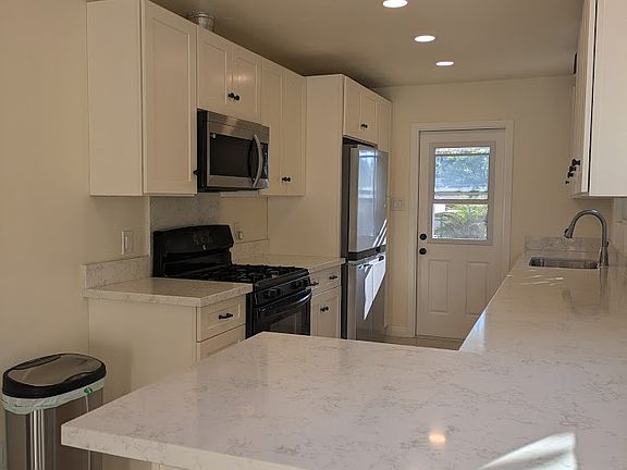Newly remodeled kitchen and bar. Tons of light and storage.