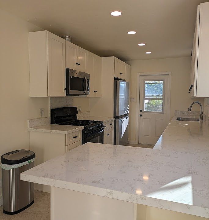 Newly remodeled kitchen and bar. Tons of light and storage.