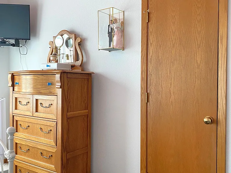 Hall BR showcasing Owners Vintage Barbie & Ken, Samsung TV w/Roku Remote & DVD Player, Oak 5-Drawer Chest, & the only Clothing Closet in the House