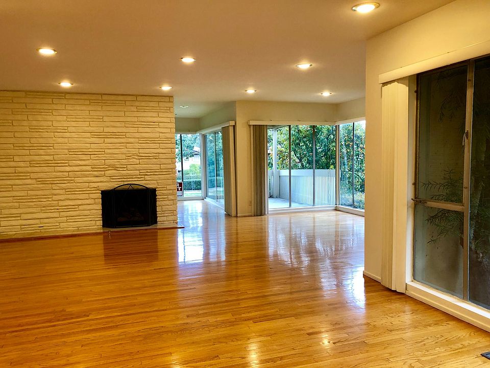 Main Living Area - Open Concept. Fresh Paint - Newly Refinished Floors (1 of 2 Fireplaces) Bright and Sunny overlooking lush landscaping.