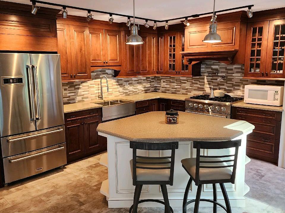 Huge kitchen with island, stainless steel appliances and door to patio. 2 chairs included.