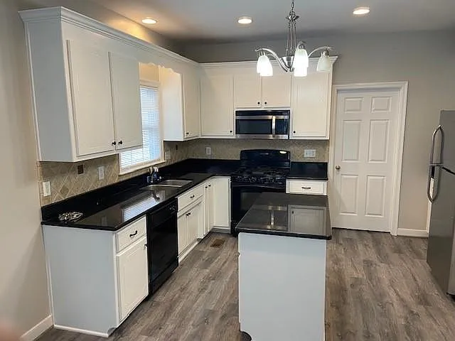 Refinished Kitchen Cabinets with new luxury vinyl flooring