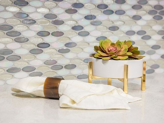 Oval iridescent tile back splash surrounds our Mindful Gray kitchens to provide that final touch of elegance.