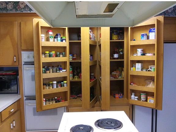 Open, cabinet filled kitchen