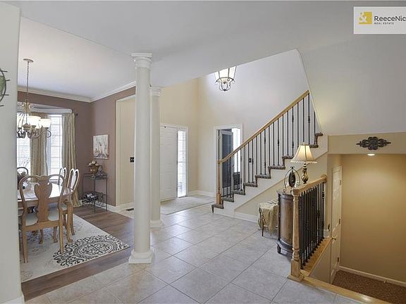 As you enter this beautiful 1.5 story home you are greeted by a two-story tile floor entry and updated staircase with patterned carpet and wrought iron spindles.
