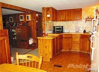 View of kitchen and portion of living room.
