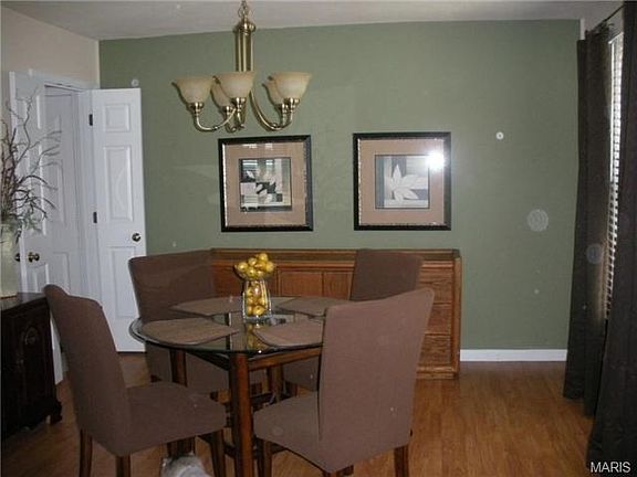 Dining room with access to kitchen through split-doorway.