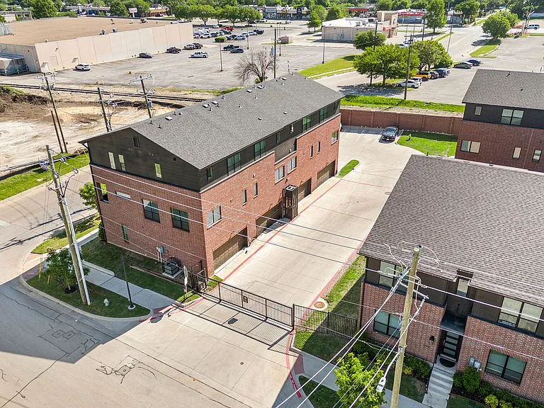 Exterior, aerial view of two-car garage and gated parking lot and street.