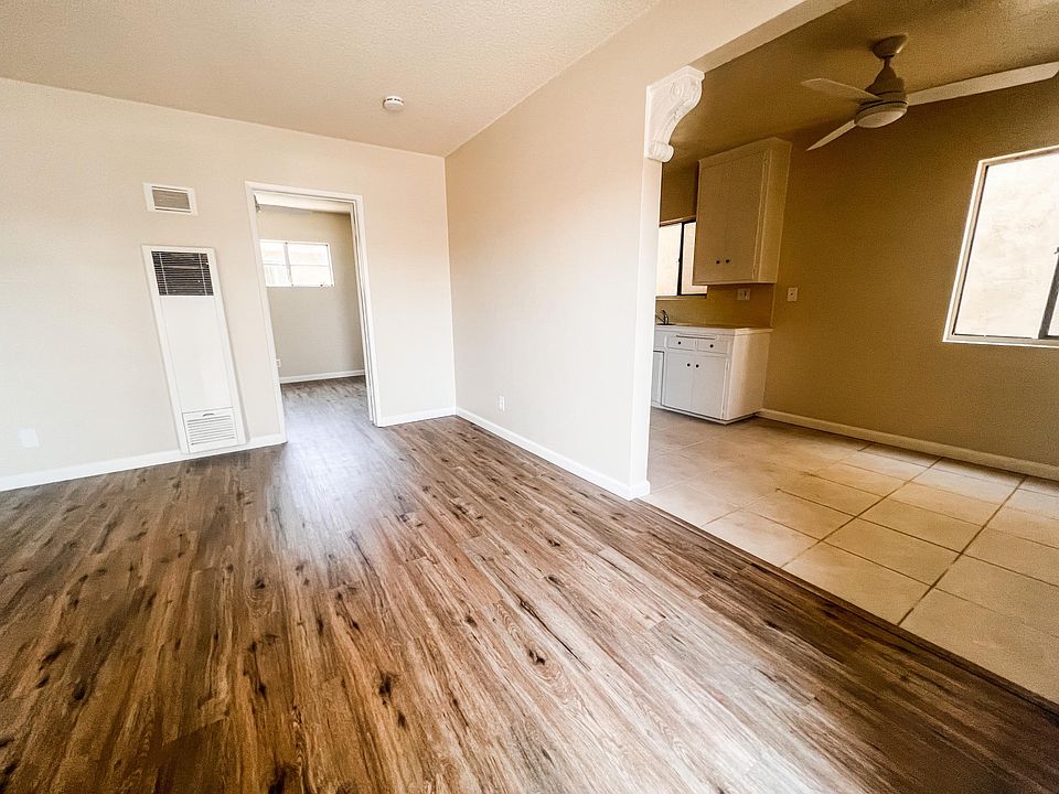 Living Room view from front door. Dining area shown adjacent to Kitchen.