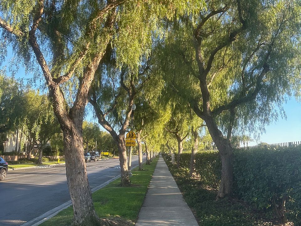 Beautifully landscaped and maintained sidewalk within the gated community.