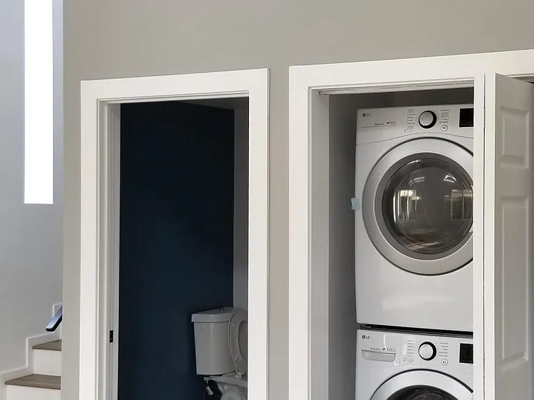Half bathroom and laundry units below mezzanine. Laundry included