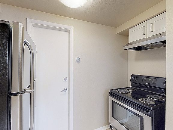 Modern kitchen featuring sleek stainless steel appliances, elegant cabinetry, and a compact, efficient layout.