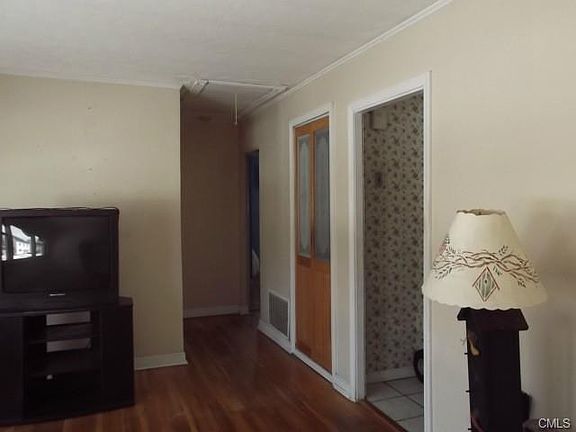 Hallway leads to two bedrooms and bathroom