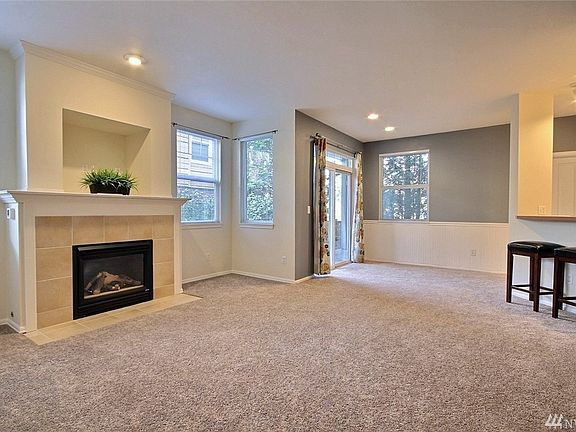 Open design with plentiful windows and cozy gas fireplace (thermostat controlled makes this an economical source of heat for this room as well).