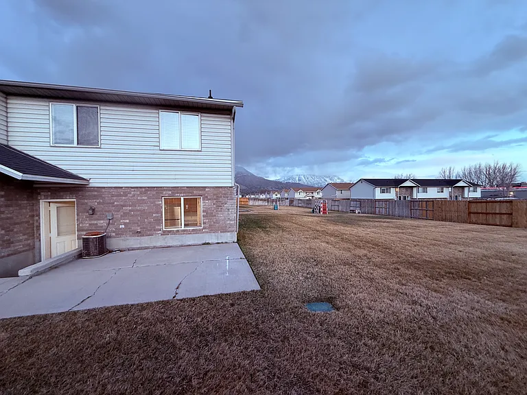 Back of unit showing back door and patio