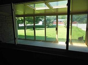 Porch. Porch view from the living room. Here you can see the skylights, and a sprawling view of the front yard.
