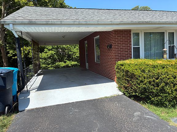 Covered carport with convenient off-street parking and easy side entry access.