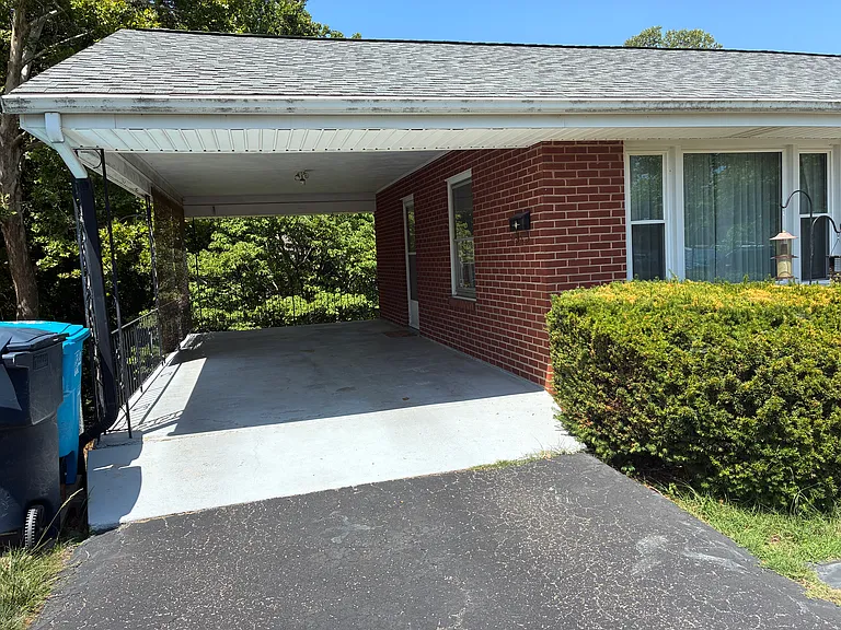 Covered carport with convenient off-street parking and easy side entry access.