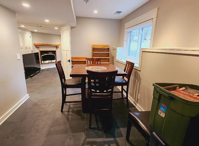 Basement open space with private office in background.