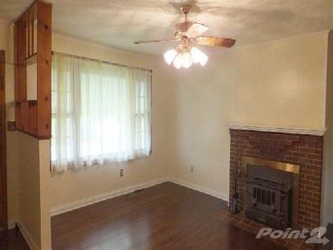 Living room is a nice size with a stove insert.