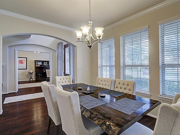 The formal dining room is lined with windows and spacious to accommodate your large table and then some!