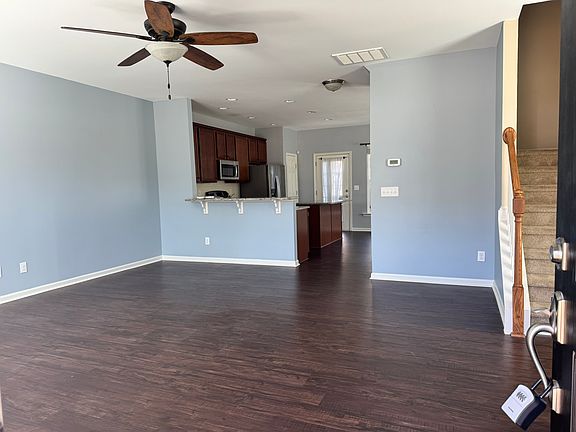Downstairs features a spacious living room, half-bath, upgraded kitchen, and dining room that opens up on to a private patio area, perfect for relaxing on sunny days.