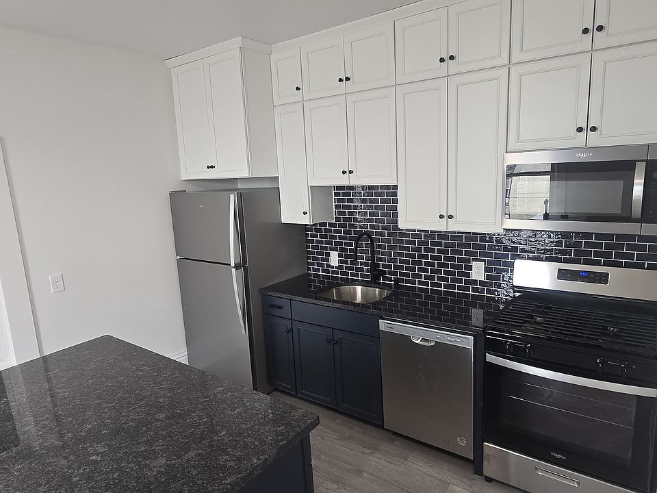 Brand new kitchen and appliances. Large kitchen island with overhang for stools.