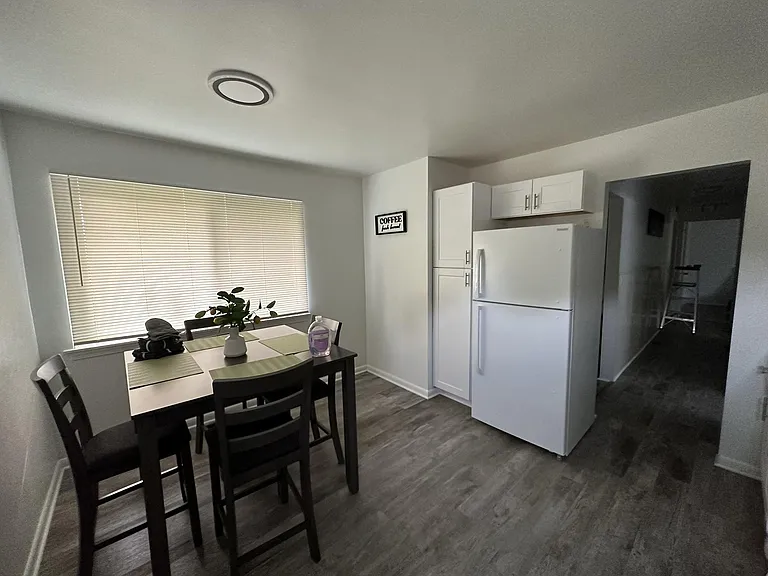 Dedicated dining area with a table for four, large window, and easy access to the kitchen for everyday meals.