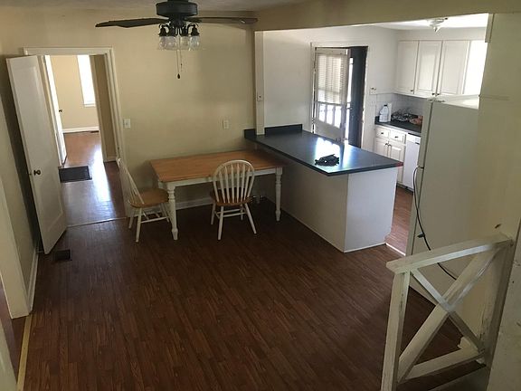 View of kitchen and hallway to two bedrooms and bath from family room