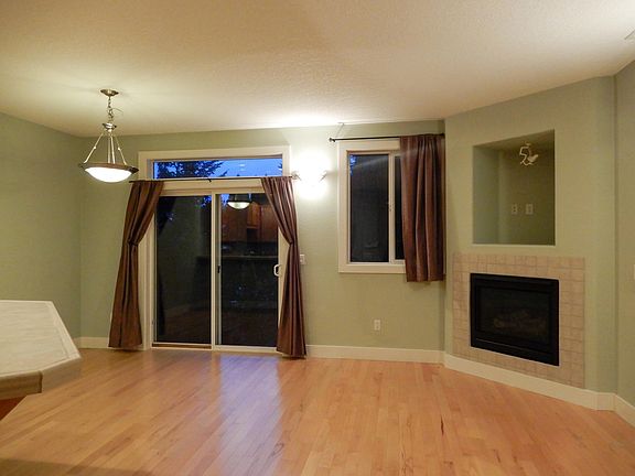 spacious living room with gas fireplace and sliding doors to back patio