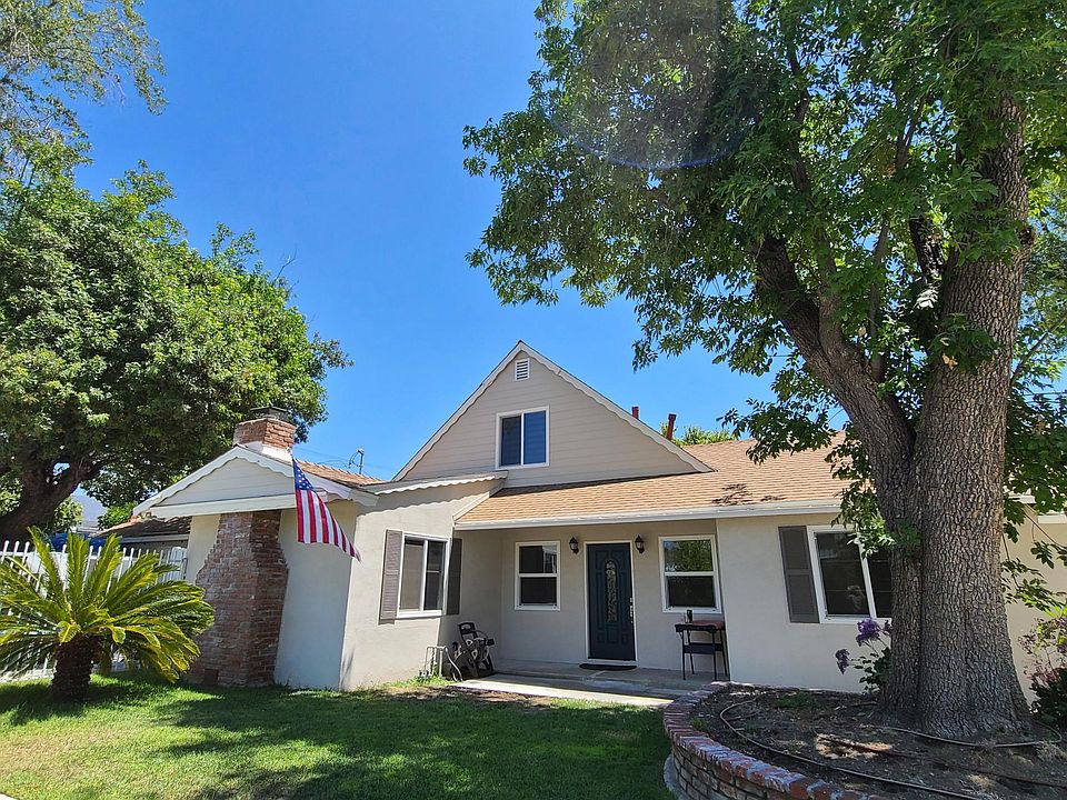 Front of the house with a beautiful tree to keep the house cool during summer time.