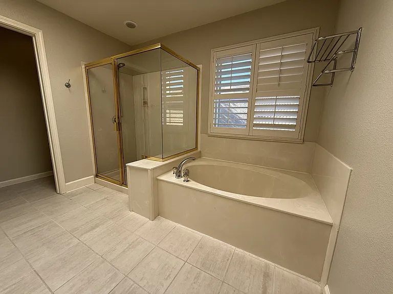 Primary Bathroom with soaking tub and a separate shower and dual sink vanity