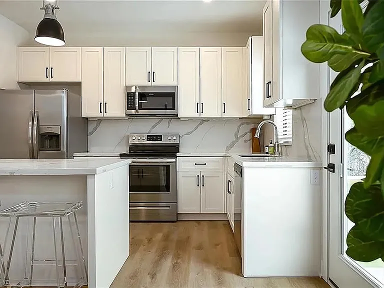 Modern kitchen featuring quartz-style countertops, stainless steel appliances, custom cabinetry, and open-concept design.

Photos are representative and finishes or layouts may vary slightly by unit.