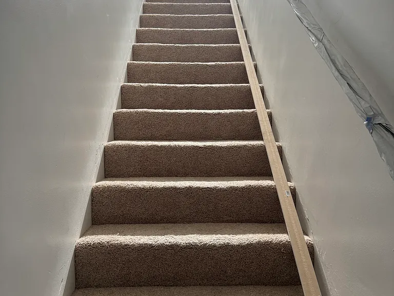 Stairs with new carpet baseboard will be installed