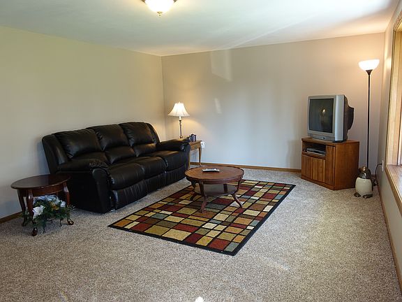 Living room with new paint ,carpet and a bay window. 2 x 6 construction. No picture holes ,any where in the house.