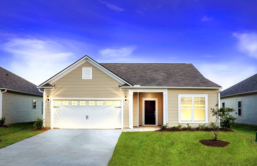 Bedrock Model New Home Exterior LC2A at Twilight with glass window inserts on the garage door.
