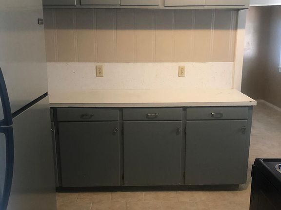 Kitchen with refrigerator, stove and microwave