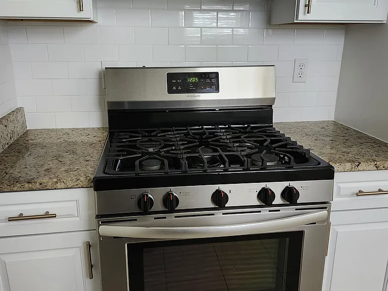 Modern gas stove with microwave; sleek design! Makes great tasty meals!