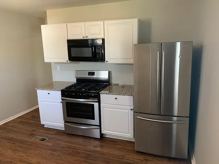 Kitchen supplied with stove, microwave and refrigerator