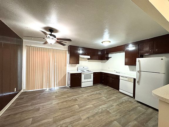 Kitchen features ample storage, breakfast nook, new fridge, and the sliding door to your back patio.