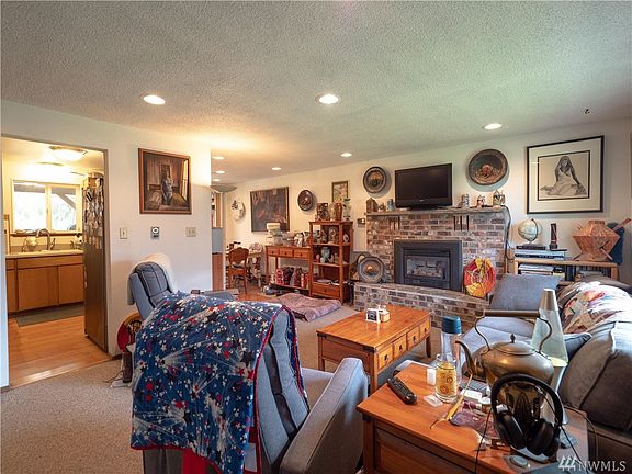 Ample sized livingroom with natural gas fireplace insert.