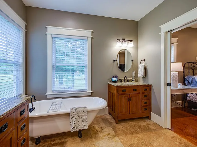 Master bath with claw-foot tub, large shower, two sinks, and separate toilet room.