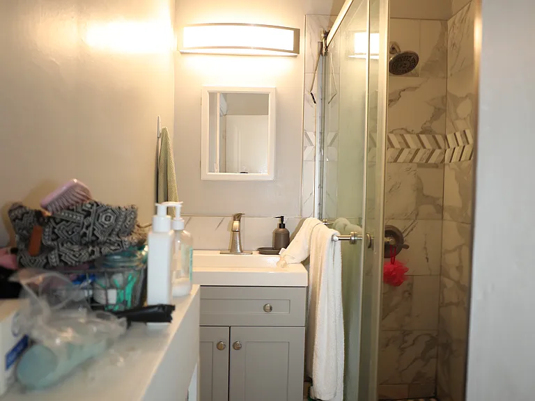 Bathroom with vanity, mirror, and storage