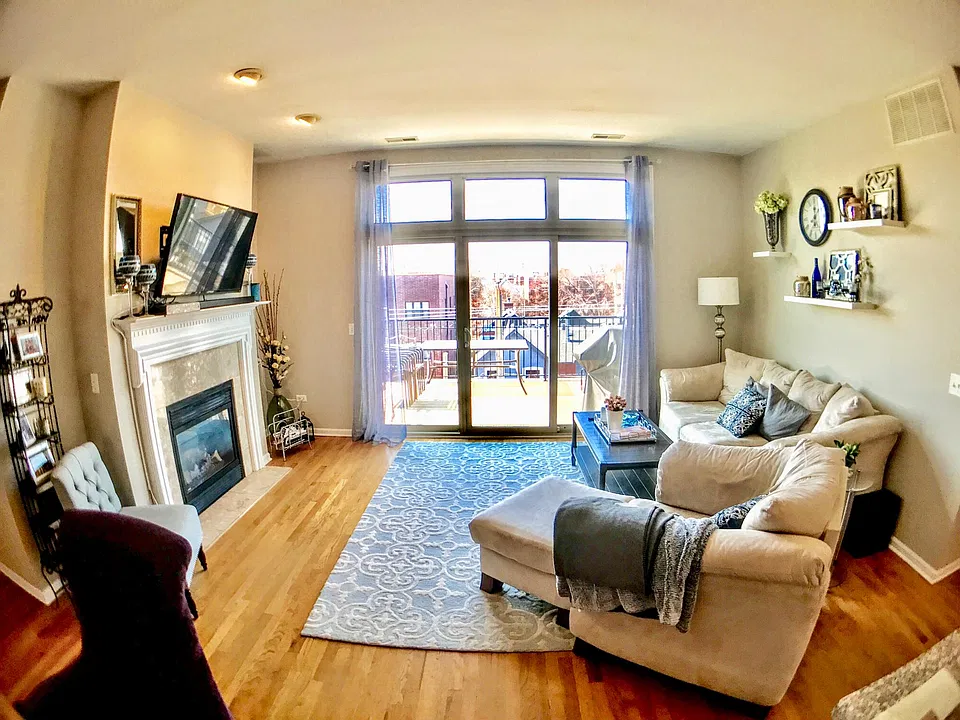 Living room, hardwood floor, fireplace, private balcony off of living room.