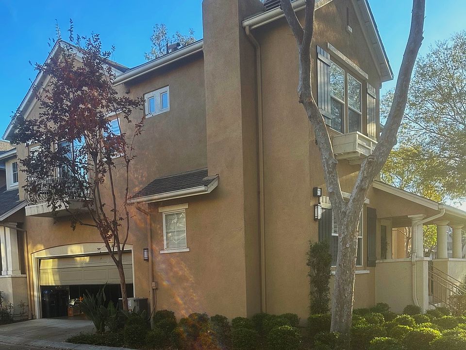 This view shows the 2 car garage door, the chimney, and a bit of the front door covered porch/patio.