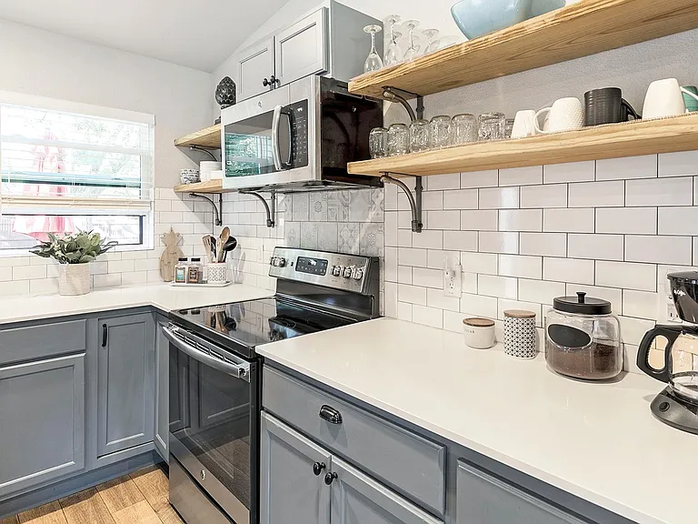 Fully-stocked kitchen with floating shelves